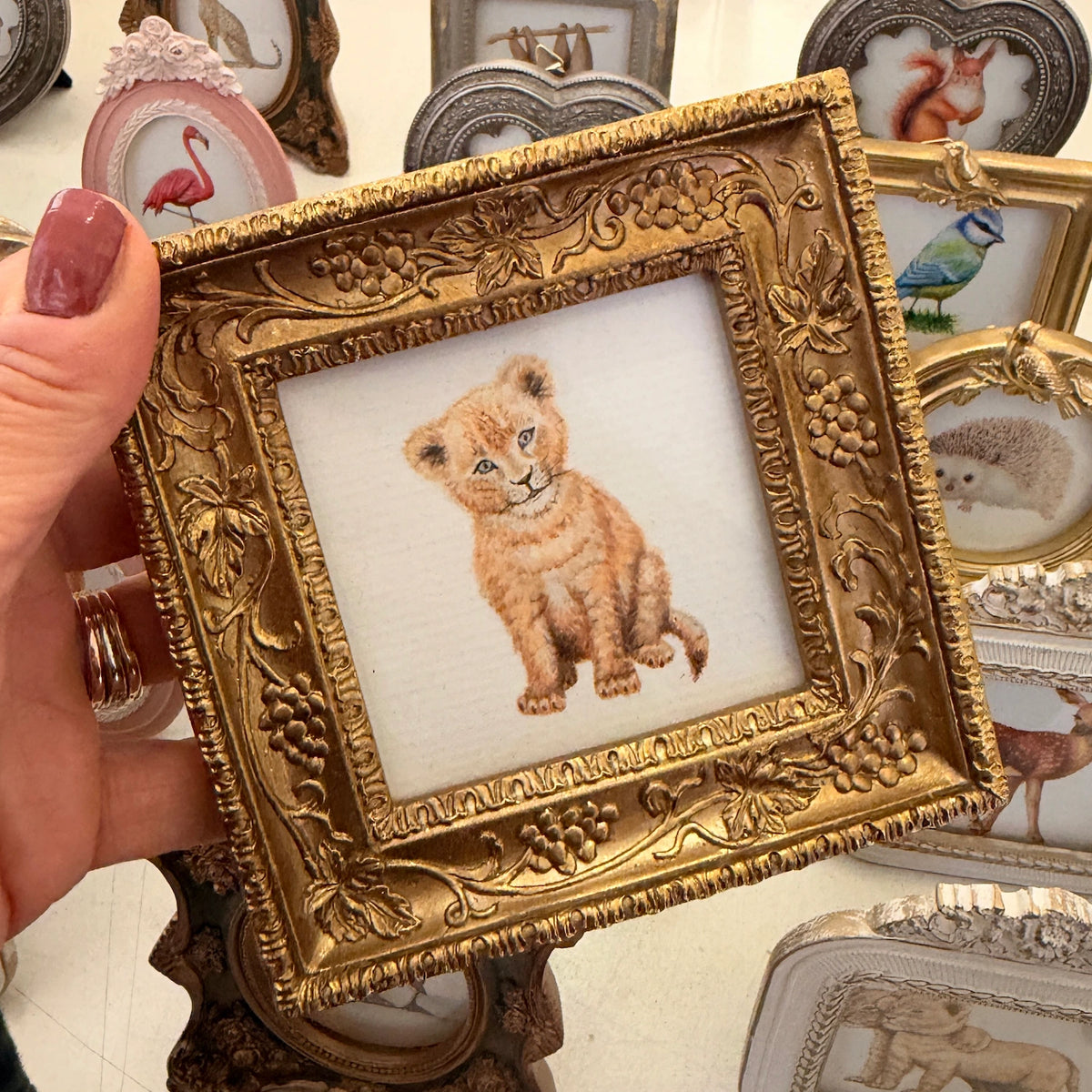 Gold colored bird frame with sloth art print