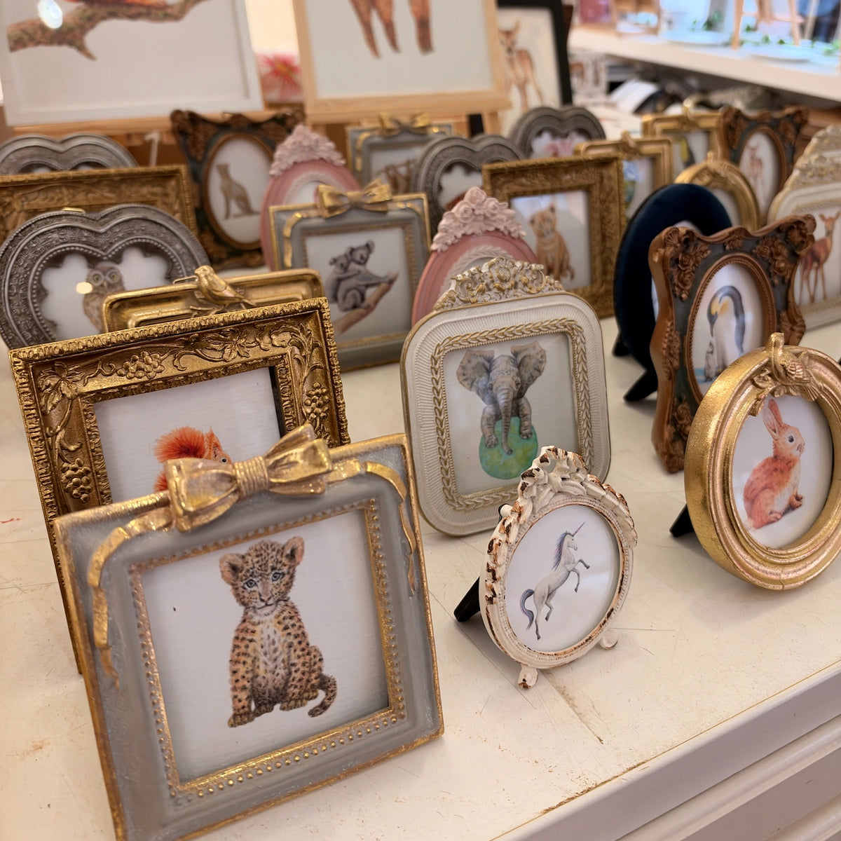 Gold colored bird frame with sloth art print